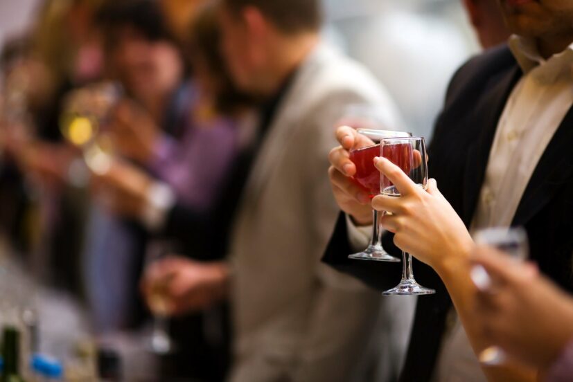 Holiday Event people cheering each other with champagne and wine. background is blurred