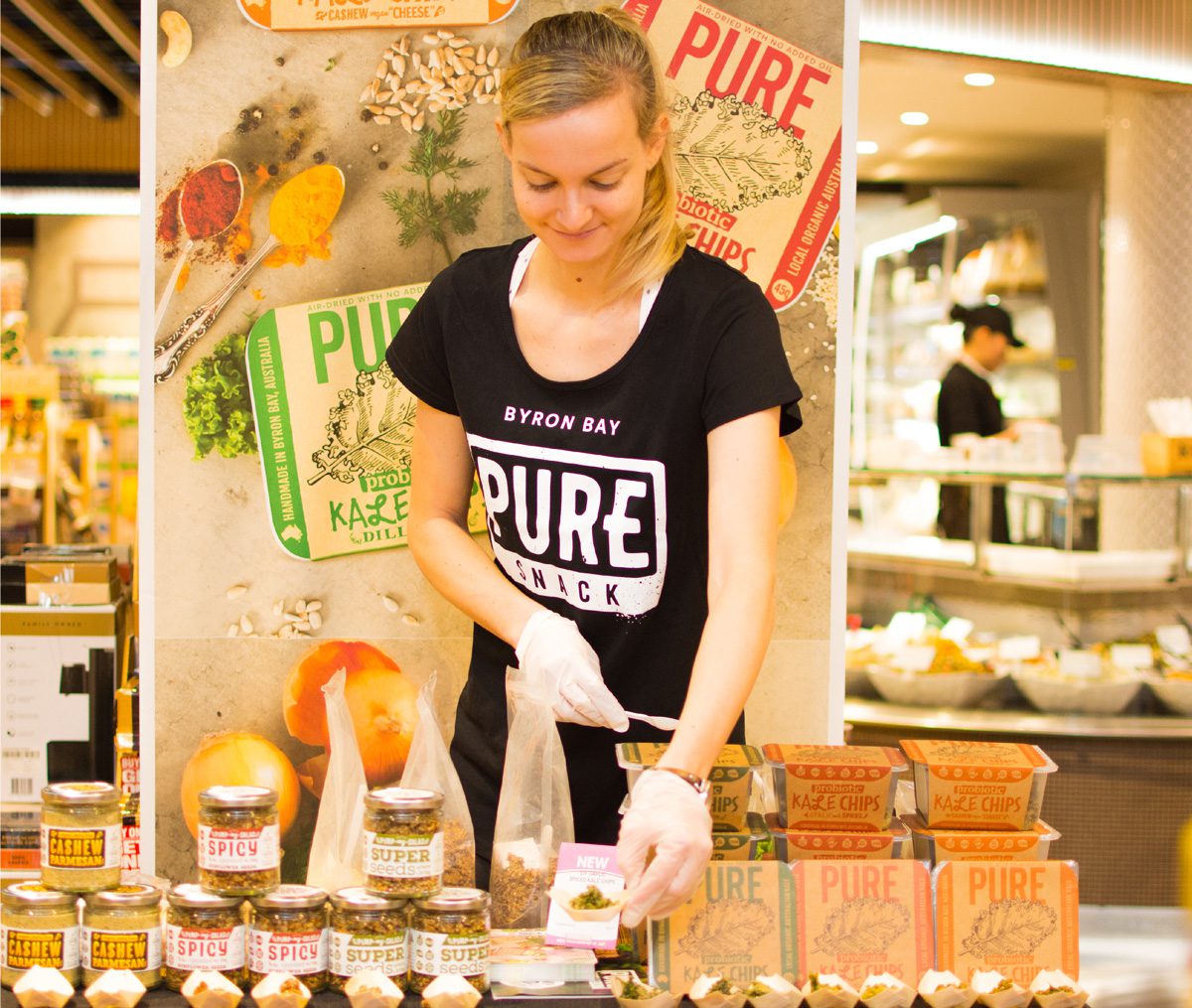 A food demonstrator setting up a display in a retail store